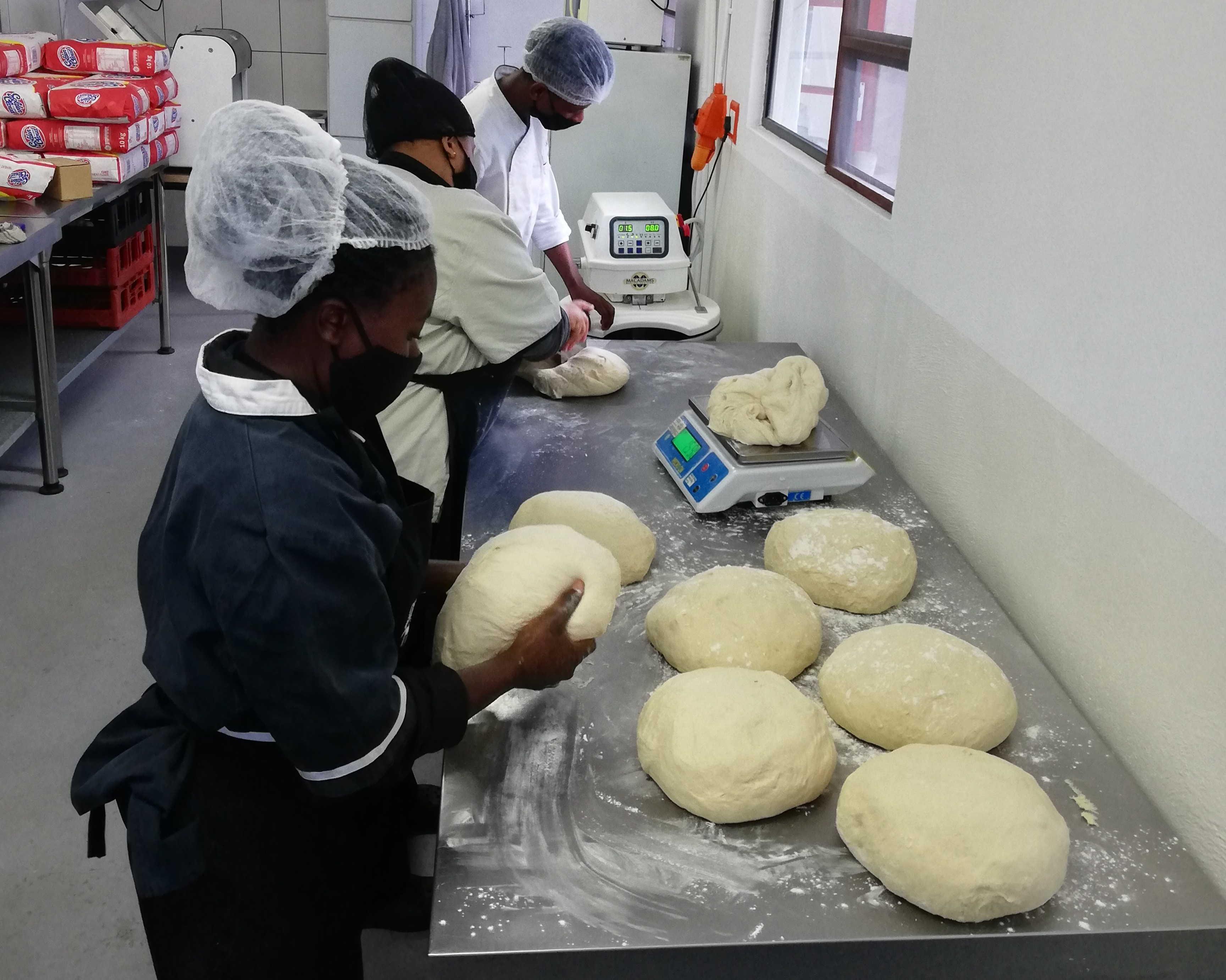 A group of women in chef aprons